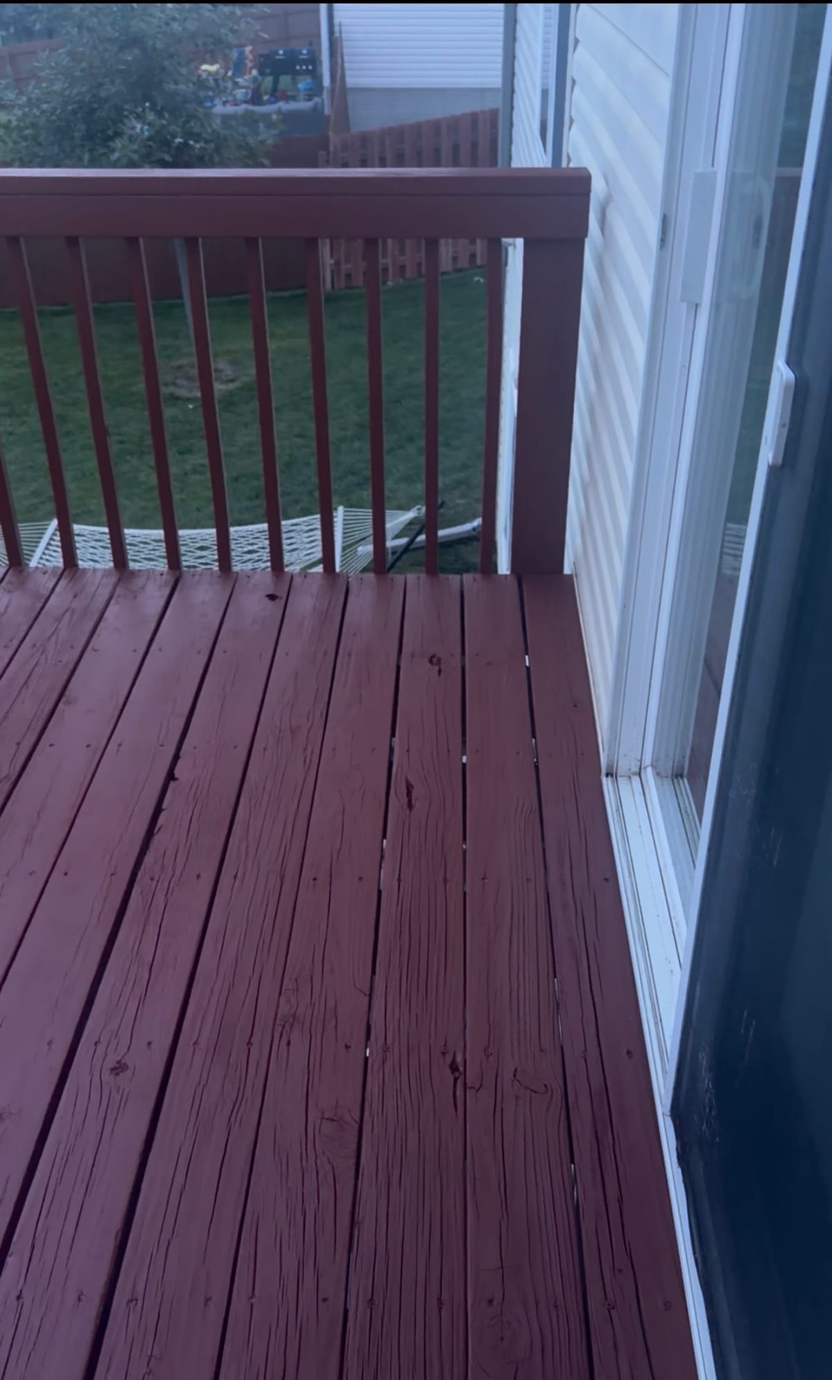 Wooden deck restored with a rich mahogany stain and sealed finish