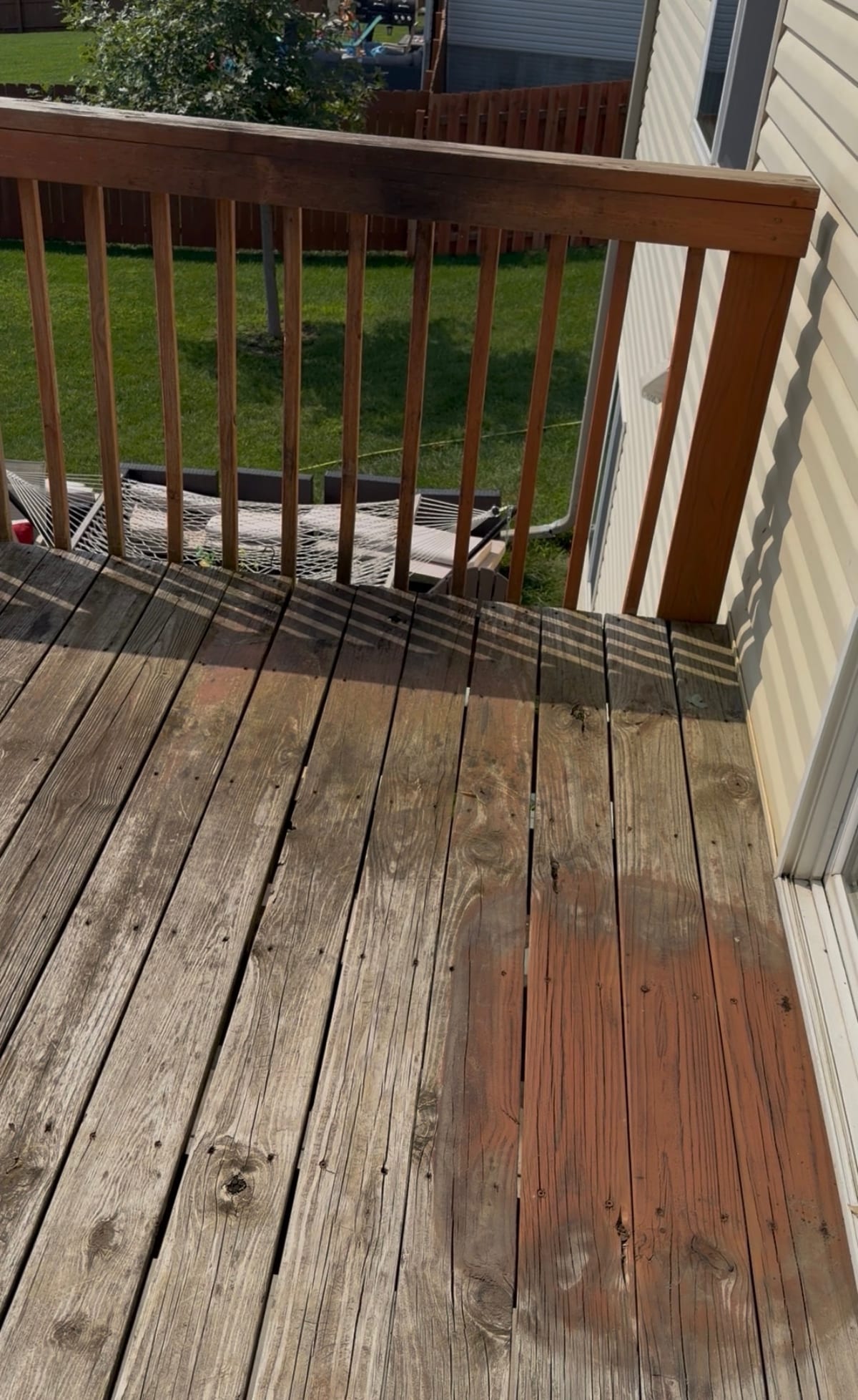 Weathered gray wooden deck with worn, faded boards before restoration